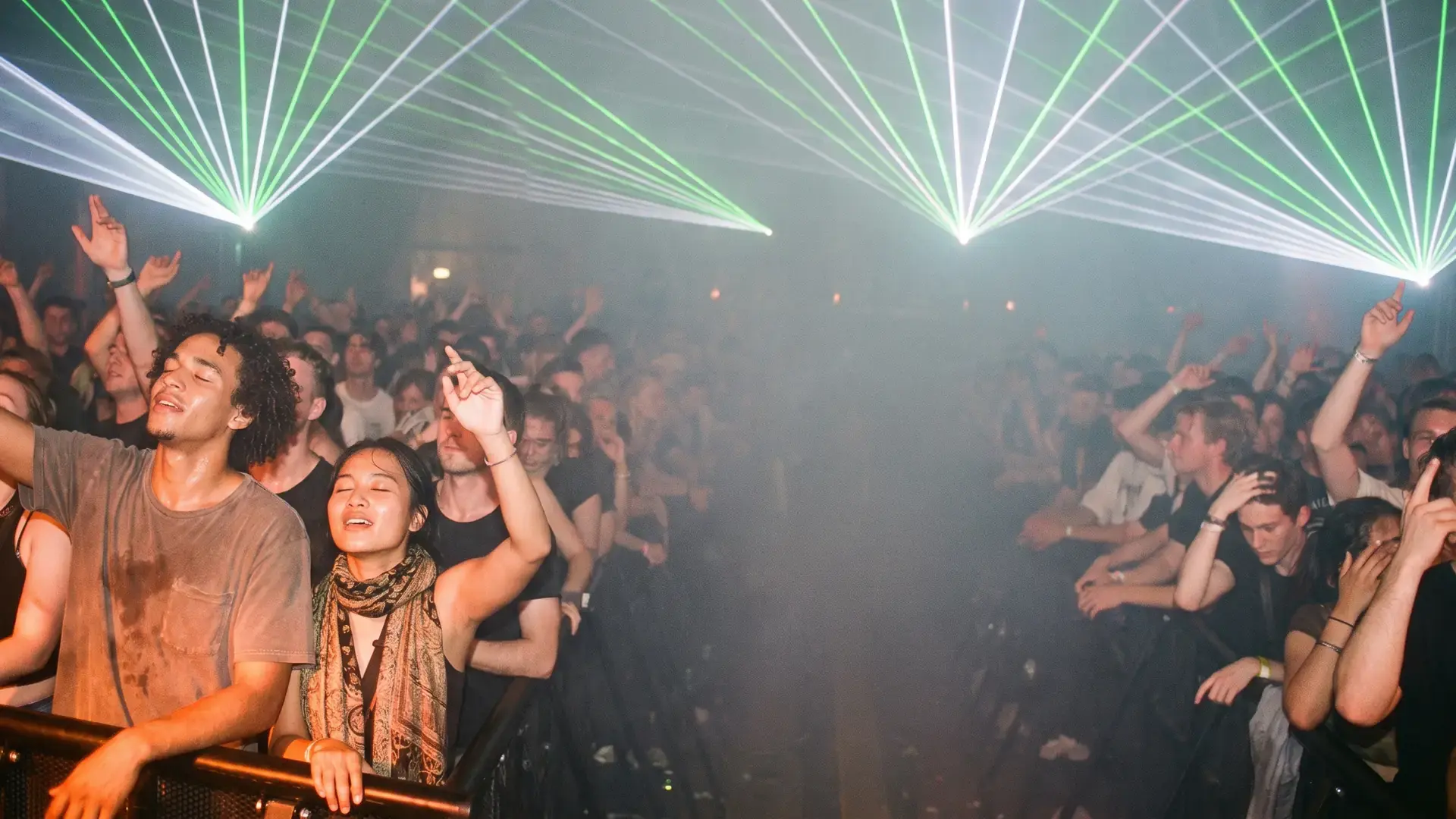Hands in the air under green laser light at the drop: the trance label directory