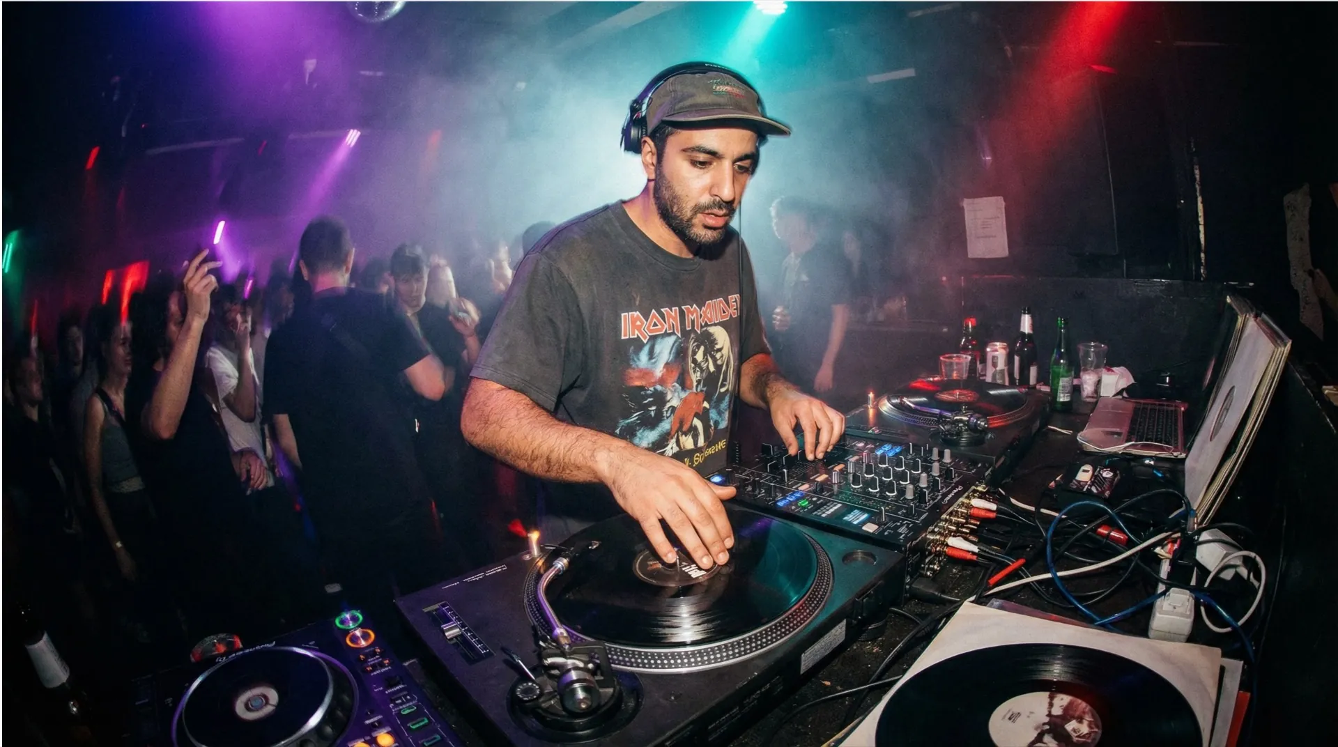 EDM DJ performing to a packed club crowd